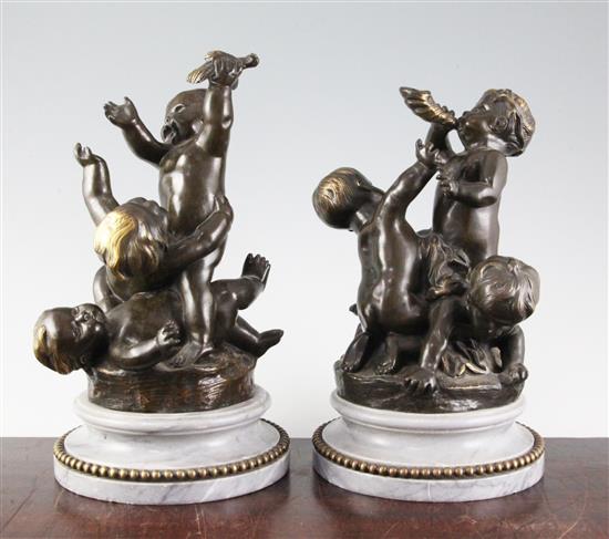 A pair of bronze figural groups of frollicking putti, 10.75in.